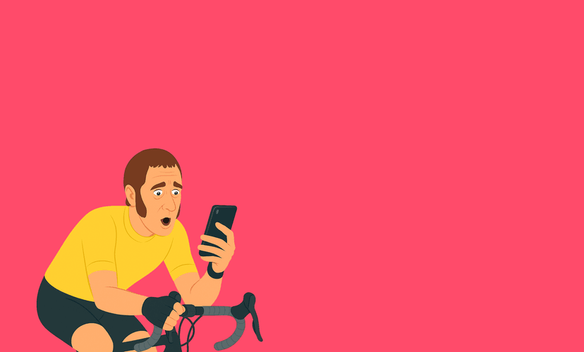 Person riding a bicycle while checking their phone